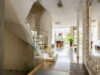 Golden glamourous house hallway with large mirror and garden view