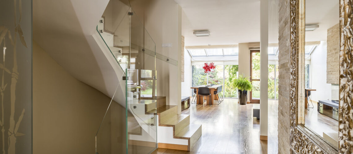 Golden glamourous house hallway with large mirror and garden view